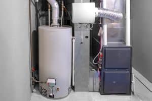 A residential basement utility area contains a water heater, furnace, ductwork, and connected plumbing and ventilation pipes.